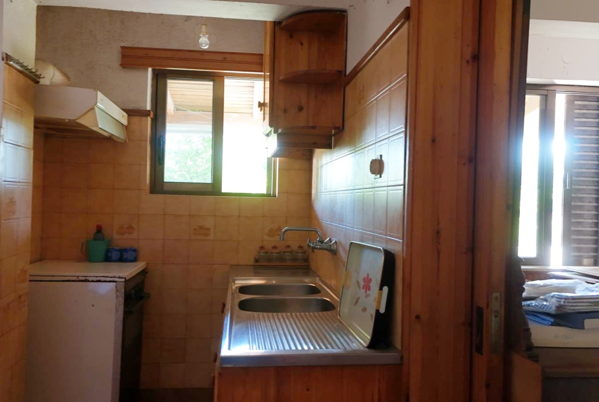 Two-bedroom ground floor apartment with a spacious plot & within walking distance to the beach in Kalyves