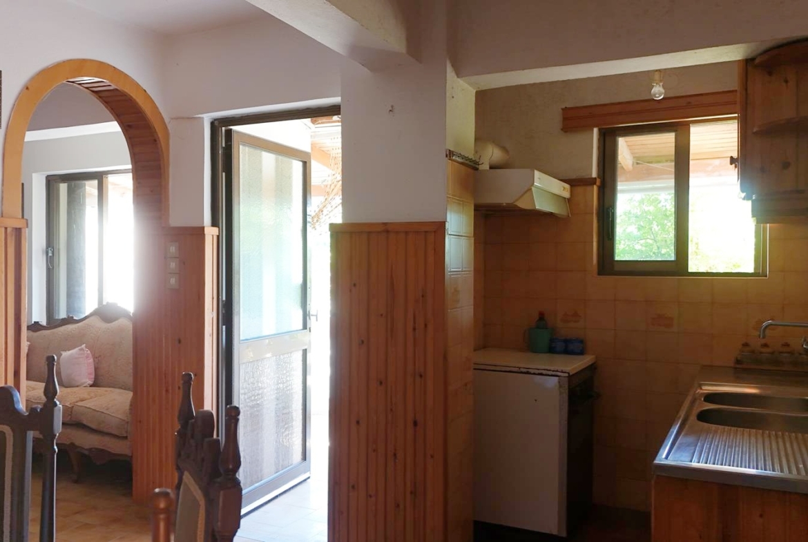 Two-bedroom ground floor apartment with a spacious plot & within walking distance to the beach in Kalyves