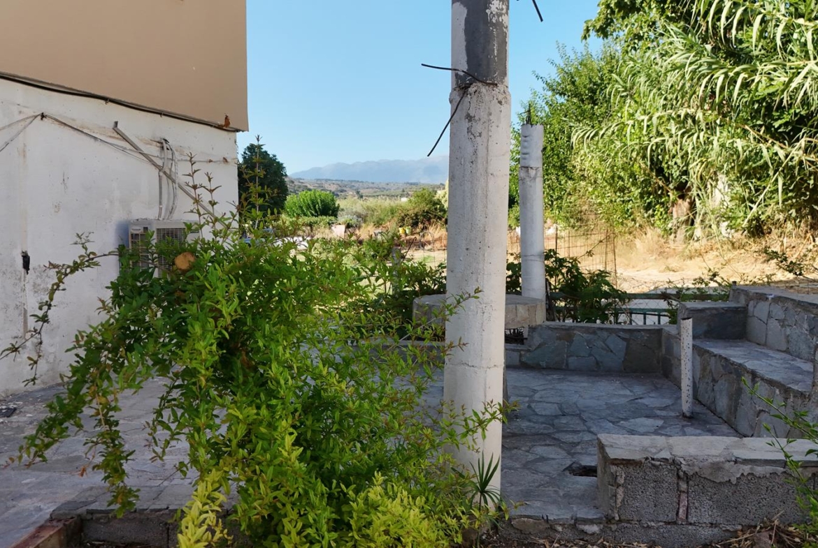Two-bedroom ground floor apartment with a spacious plot & within walking distance to the beach in Kalyves
