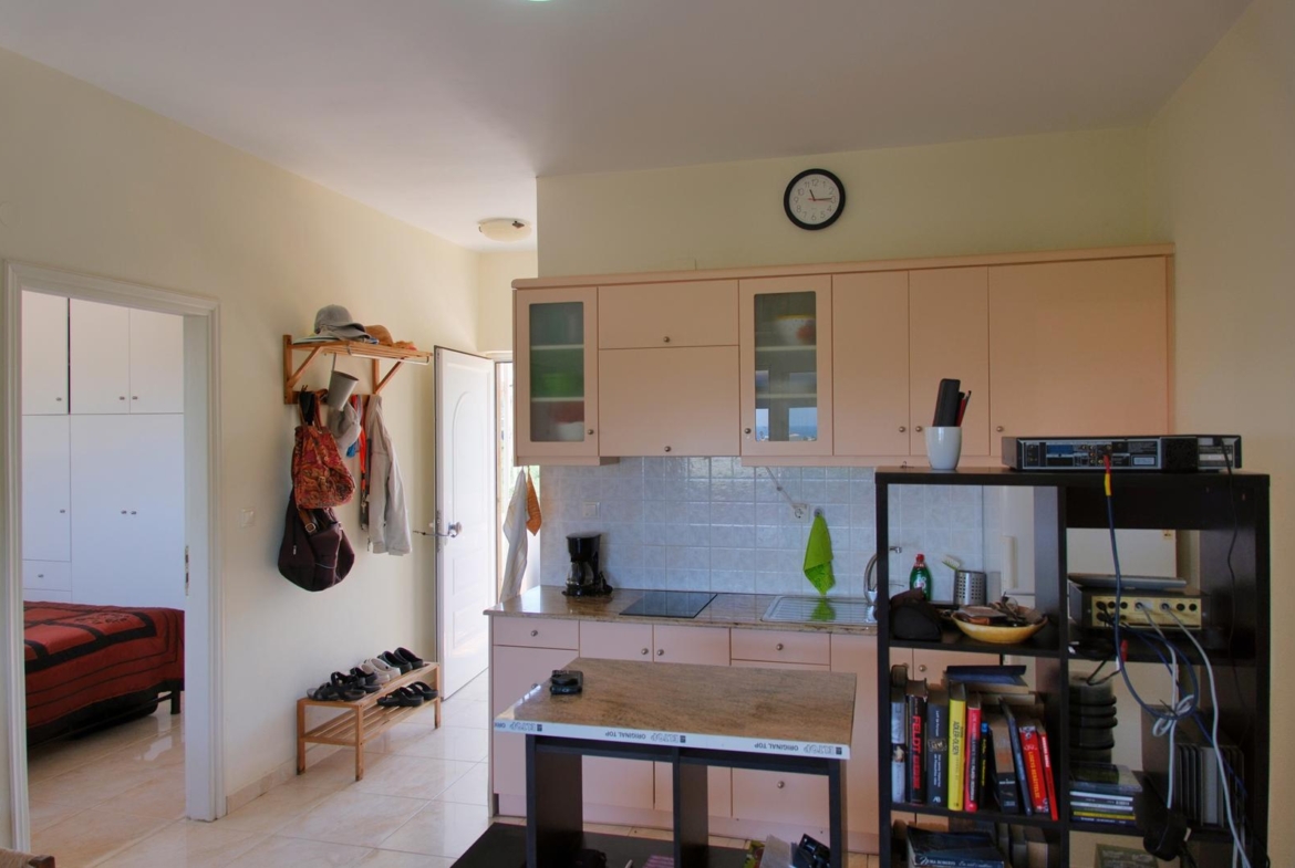 Second floor one-bedroom apartment with a sea view & shared pool in Tavronitis