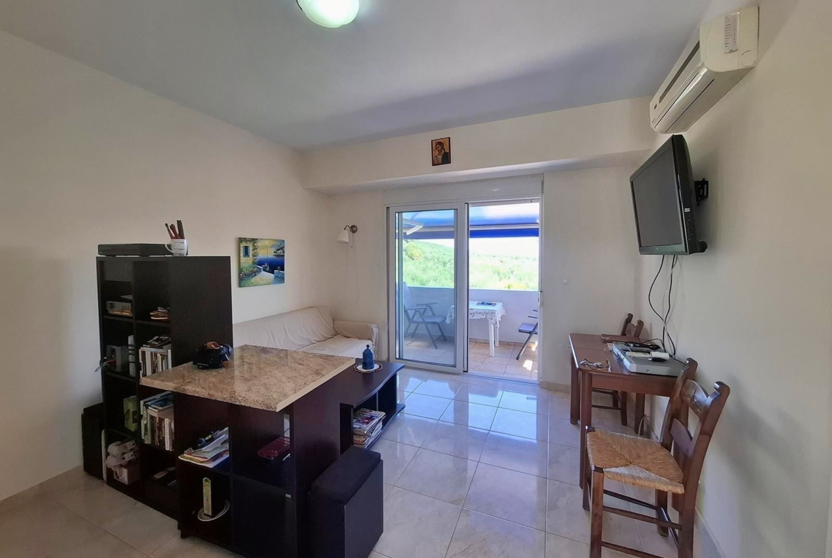 Second floor one-bedroom apartment with a sea view & shared pool in Tavronitis