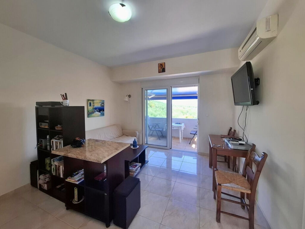 11 Second floor one-bedroom apartment with a sea view & shared pool in Tavronitis