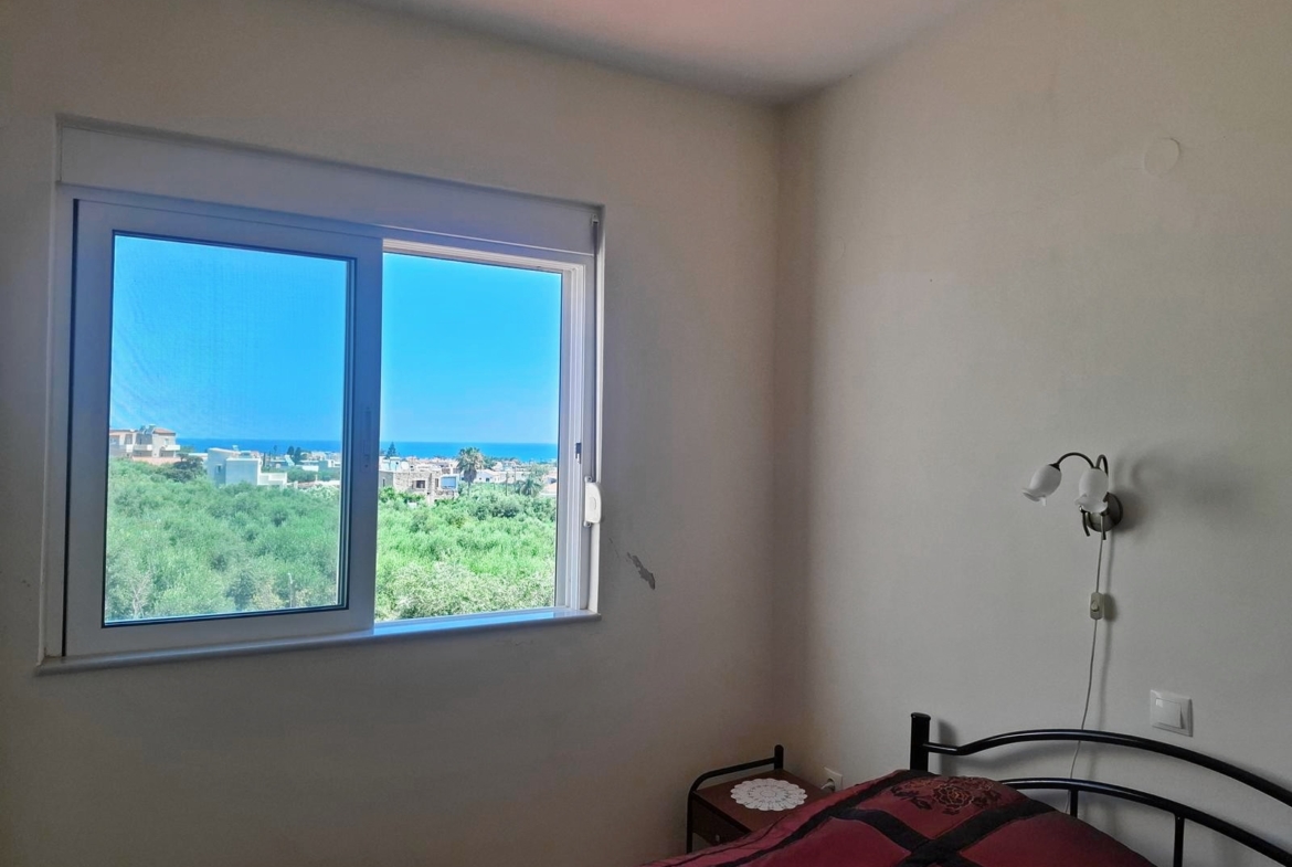 Second floor one-bedroom apartment with a sea view & shared pool in Tavronitis