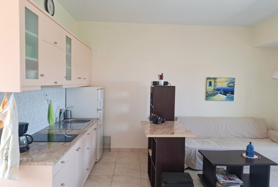 Second floor one-bedroom apartment with a sea view & shared pool in Tavronitis
