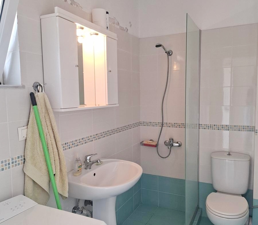 Second floor one-bedroom apartment with a sea view & shared pool in Tavronitis