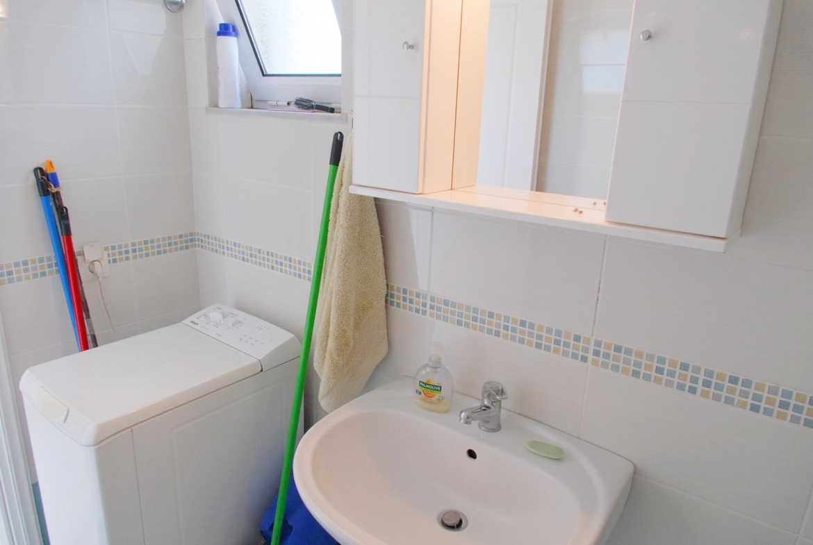 Second floor one-bedroom apartment with a sea view & shared pool in Tavronitis