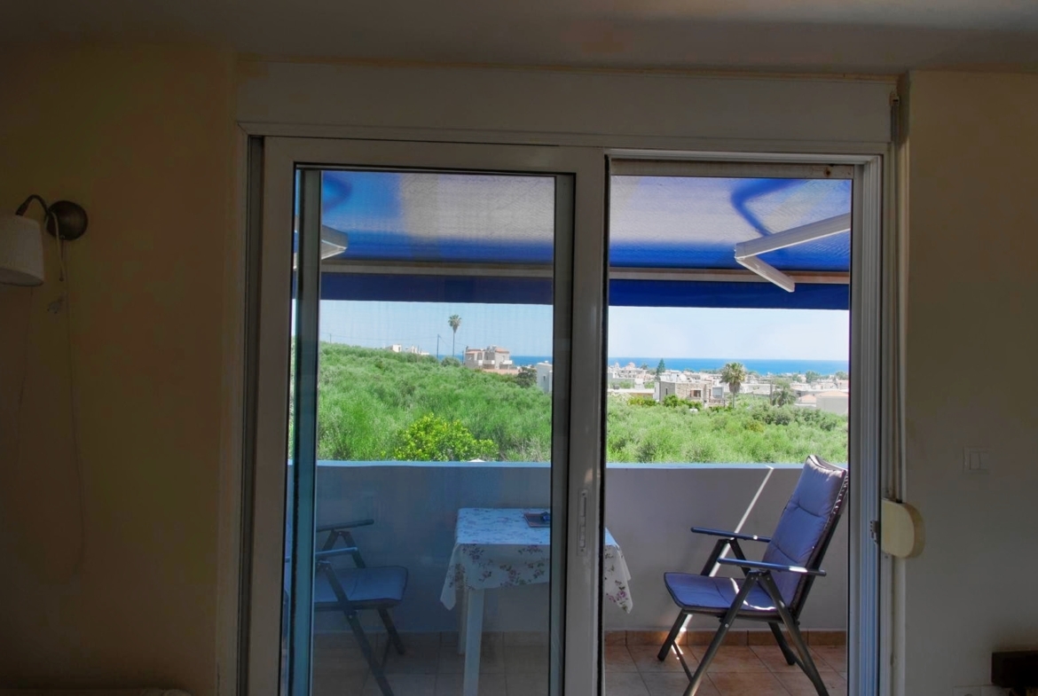 Second floor one-bedroom apartment with a sea view & shared pool in Tavronitis