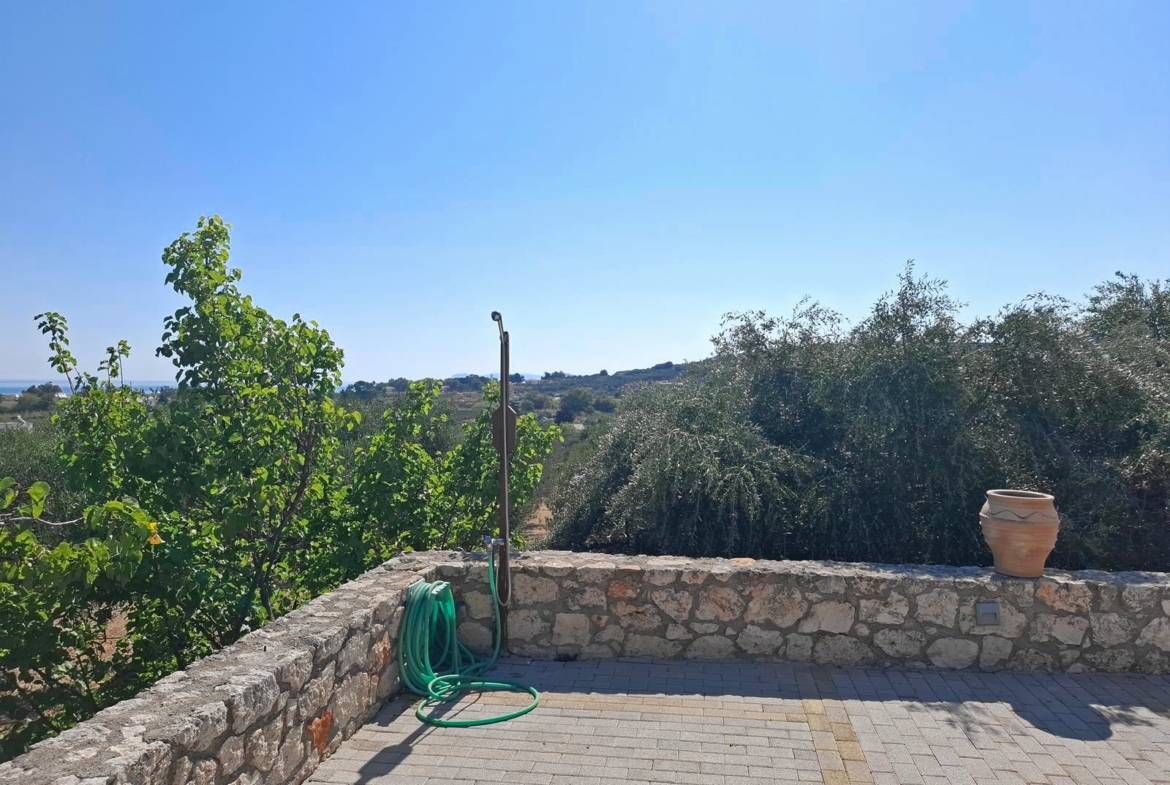 Second floor one-bedroom apartment with a sea view & shared pool in Tavronitis