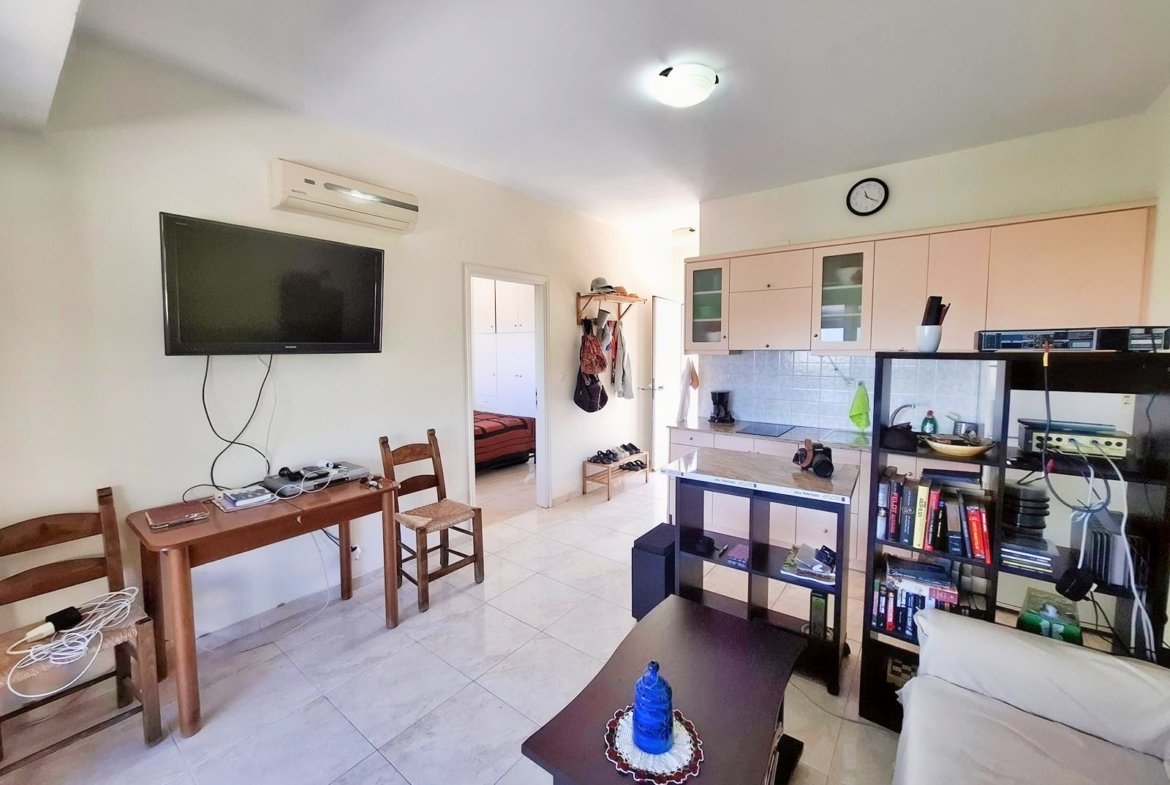 Second floor one-bedroom apartment with a sea view & shared pool in Tavronitis