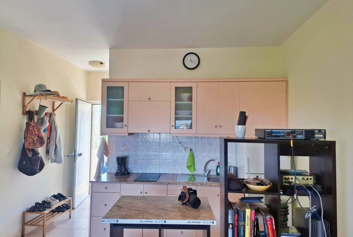 Second floor one-bedroom apartment with a sea view & shared pool in Tavronitis
